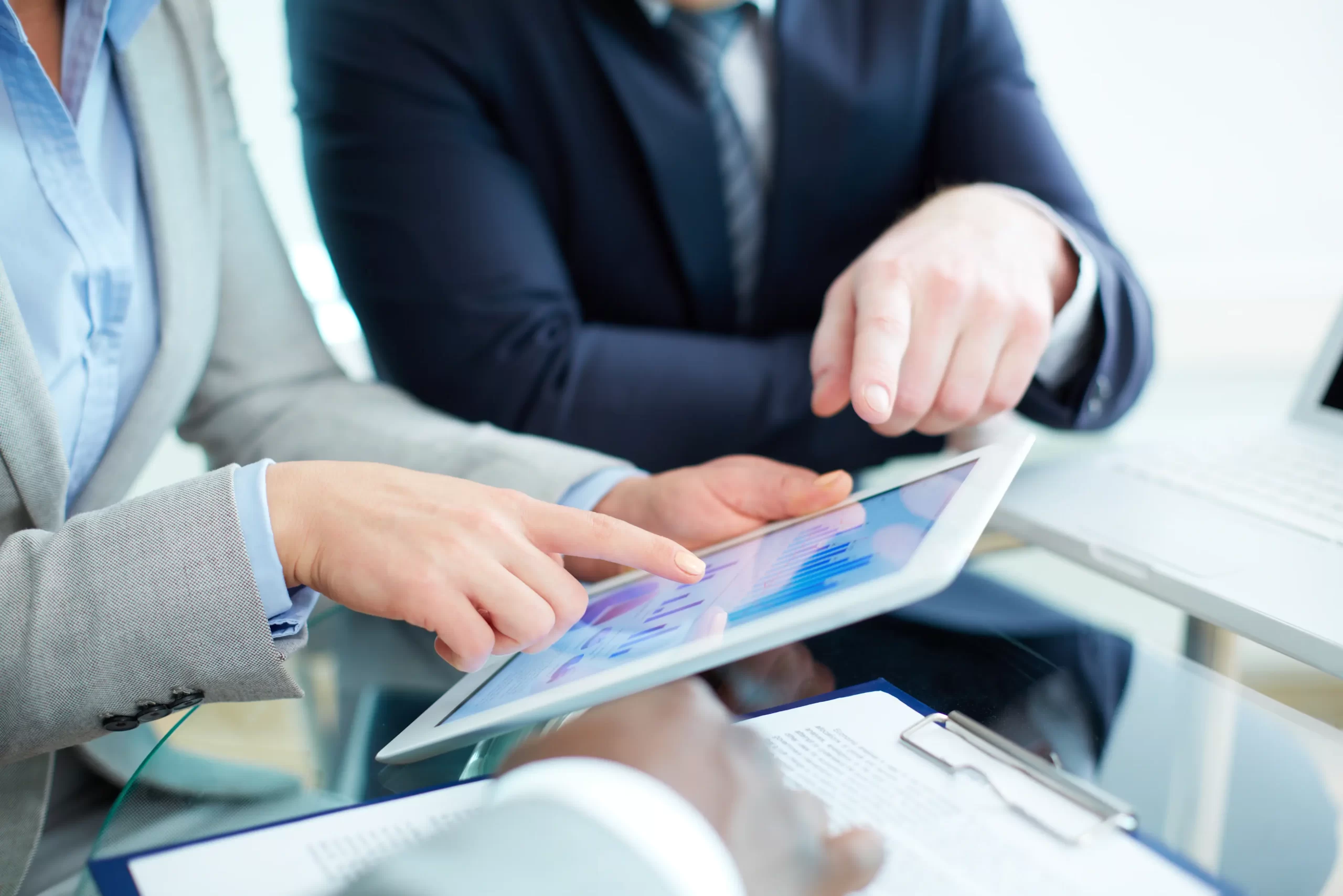 Business professionals analysing data integration charts on a tablet